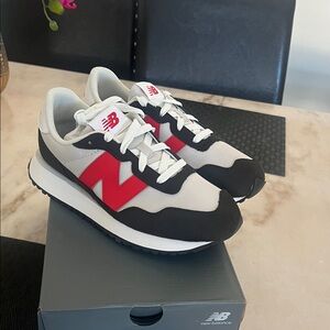 New Balance White and Black Sneakers with Red Accents
